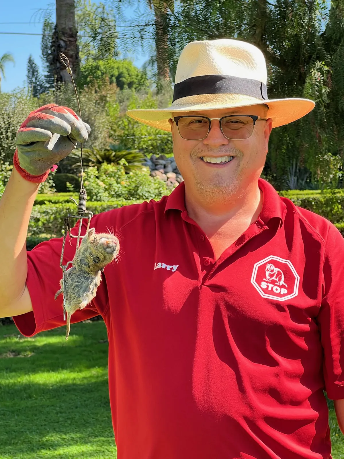 Gopher Stop technician holding a pocket gopher removed from a Corona, California yard