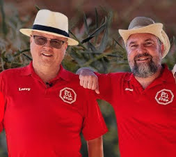 Larry and Aaron, co-founders of Gopher Stop, outdoors in red Gopher Stop polo shirts